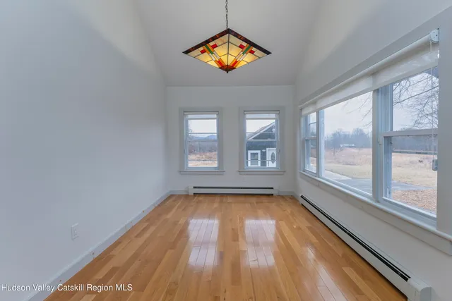 a view of a livingroom with wooden floor and a window