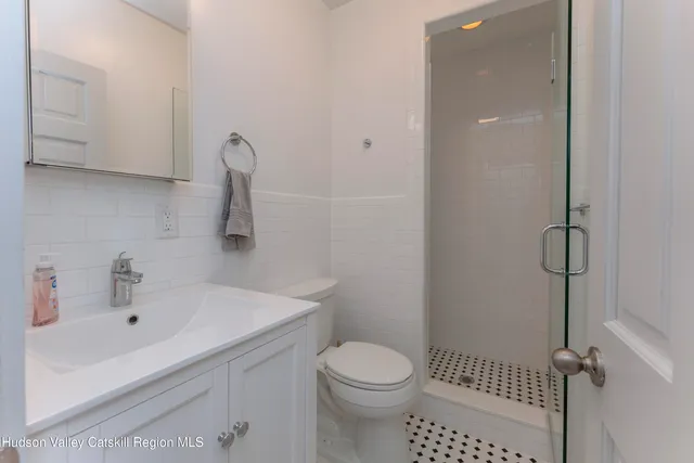 a bathroom with a sink toilet and shower