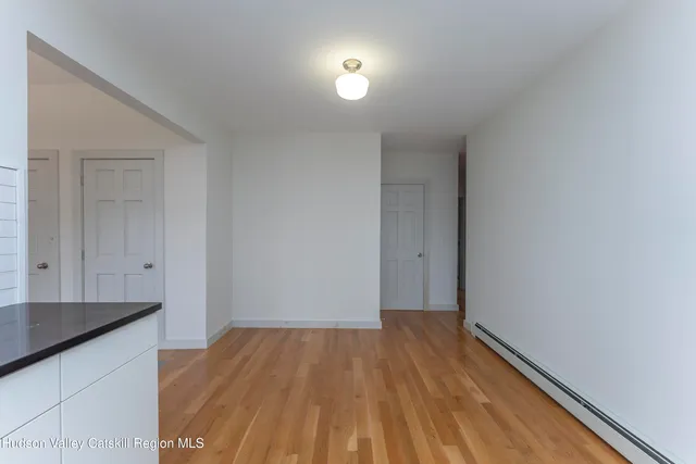 a view of a room with wooden floor and a sink