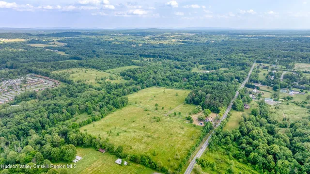 an aerial view of a houses with a yard