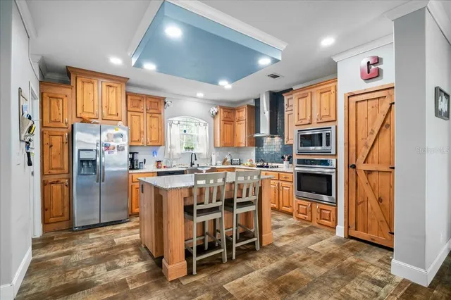 a kitchen with cabinets and wooden floor