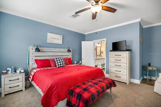 a bedroom with a large bed and a tv