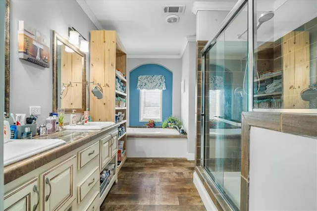 a bathroom with a granite countertop sink mirror and a bathtub