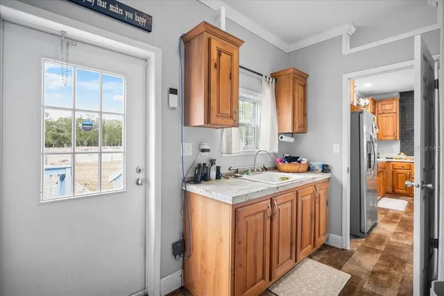 a kitchen with a stove a sink and a refrigerator