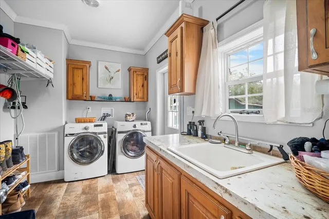 a utility room with sink dryer and washer