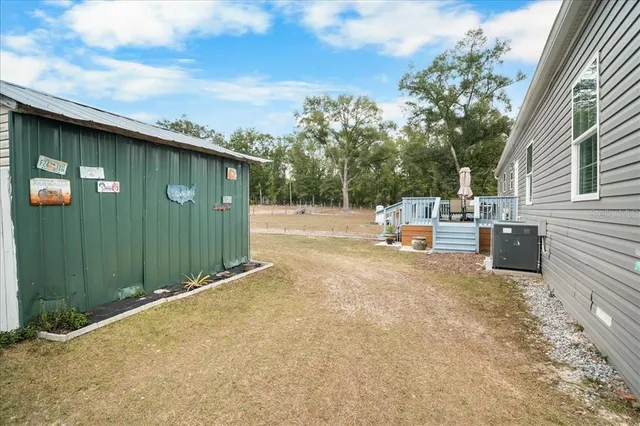 a backyard of a house with table and chairs