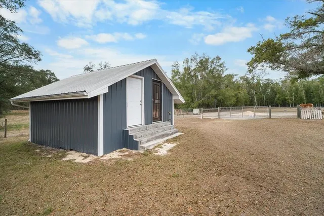 a view of house with backyard and seating area