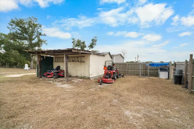 a view of a garage with a white house