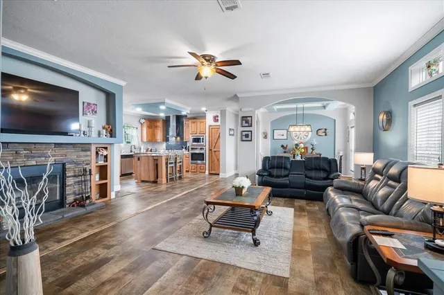 a living room with furniture a flat screen tv and a fireplace
