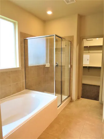 a bathroom with a bathtub and a shower