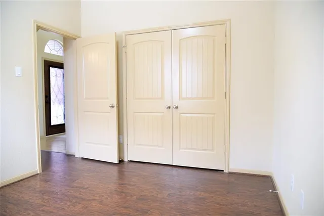 an empty room with wooden floor