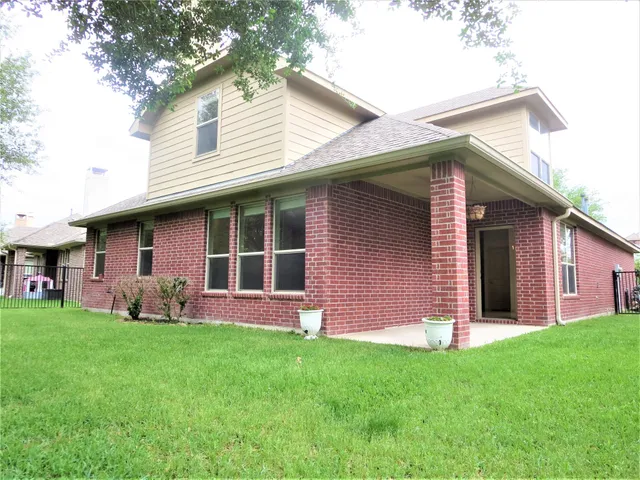 a front view of a house with a garden and yard