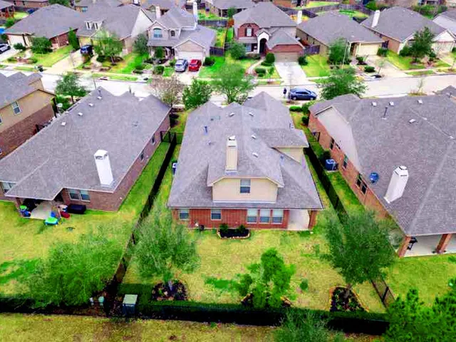 an aerial view of a house with a garden and a yard
