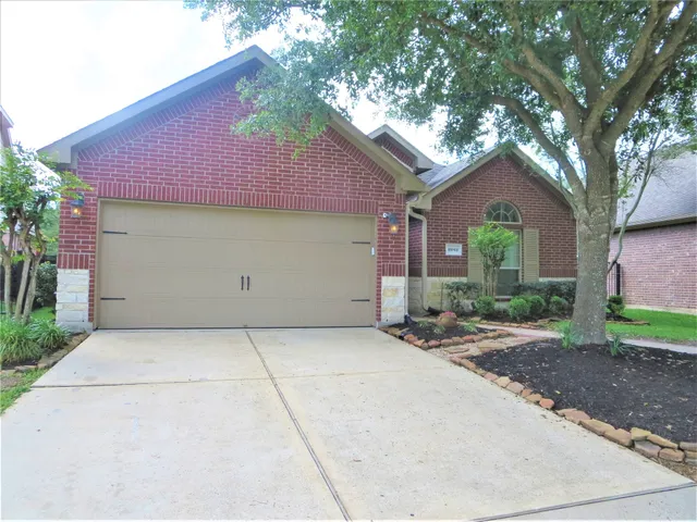 a front view of a house with yard and trees