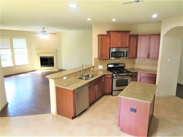 a kitchen with a stove sink and a refrigerator