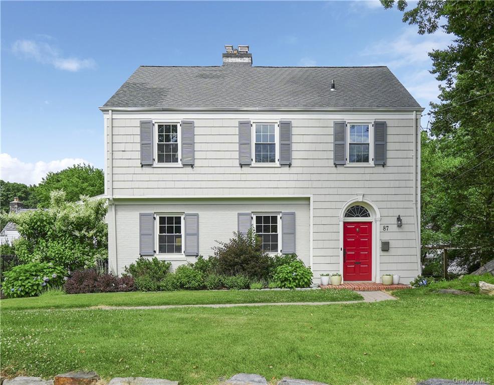 a front view of a house with a garden