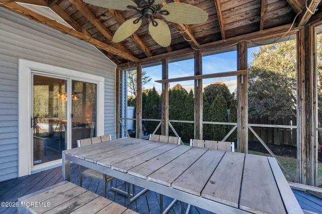 a roof deck with table and chairs