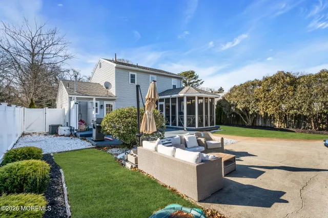 a view of a house with backyard and sitting area