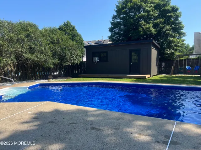 a view of a backyard with swimming pool