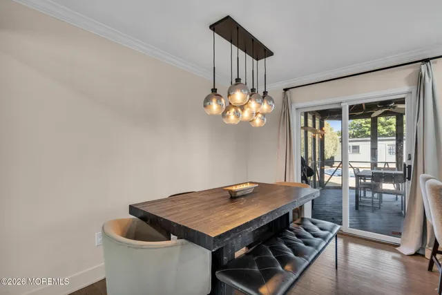 a view of a dining room with furniture wooden floor and chandelier