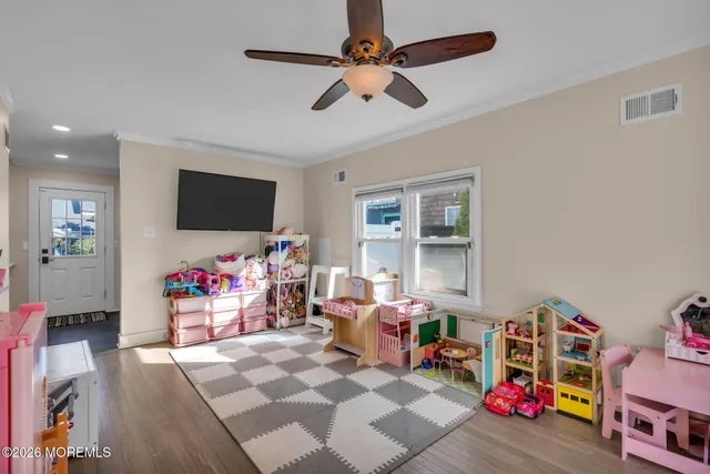 a children room with furniture and a flat screen tv