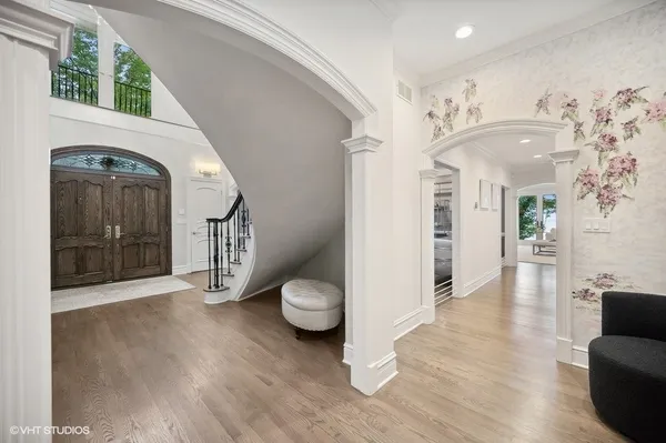 a view of a hallway with wooden floor and furniture
