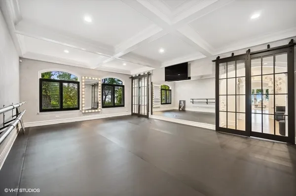 an empty room with floor to ceiling window and windows
