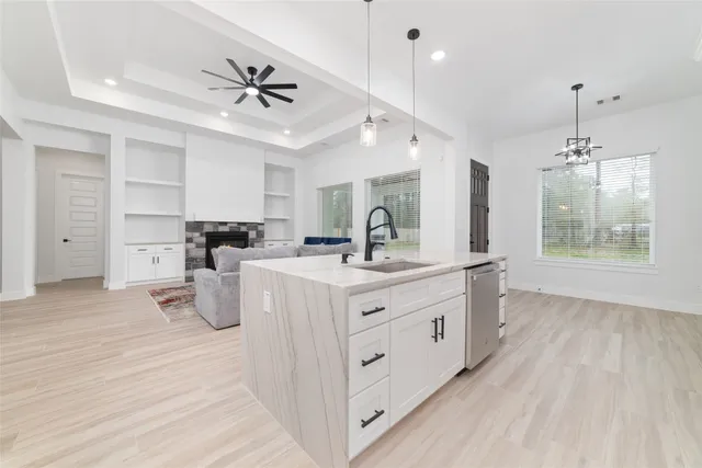 a view of a room with wooden floor and a ceiling fan