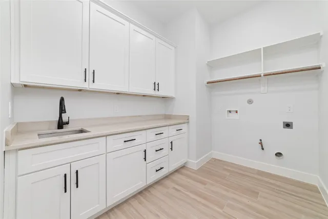 a view of a house with a yard and large tree