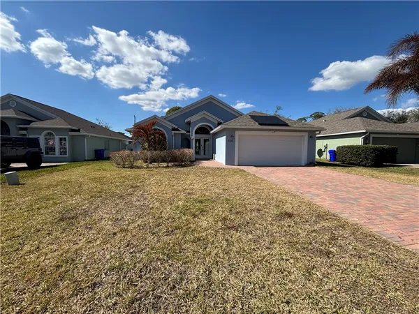 a view of a house with a yard covered in snow