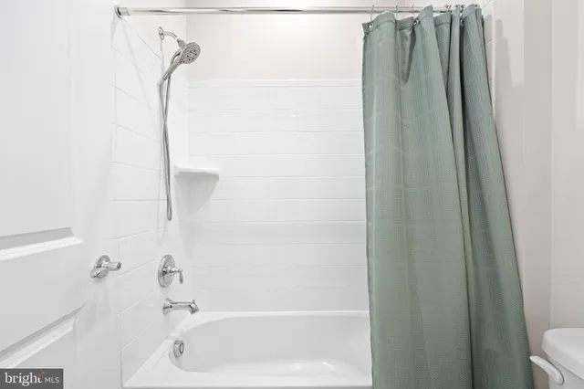 a en suite bathroom with a toilet sink and mirror