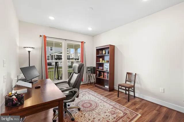 a view of a dining room and livingroom with furniture wooden floor a chandelier