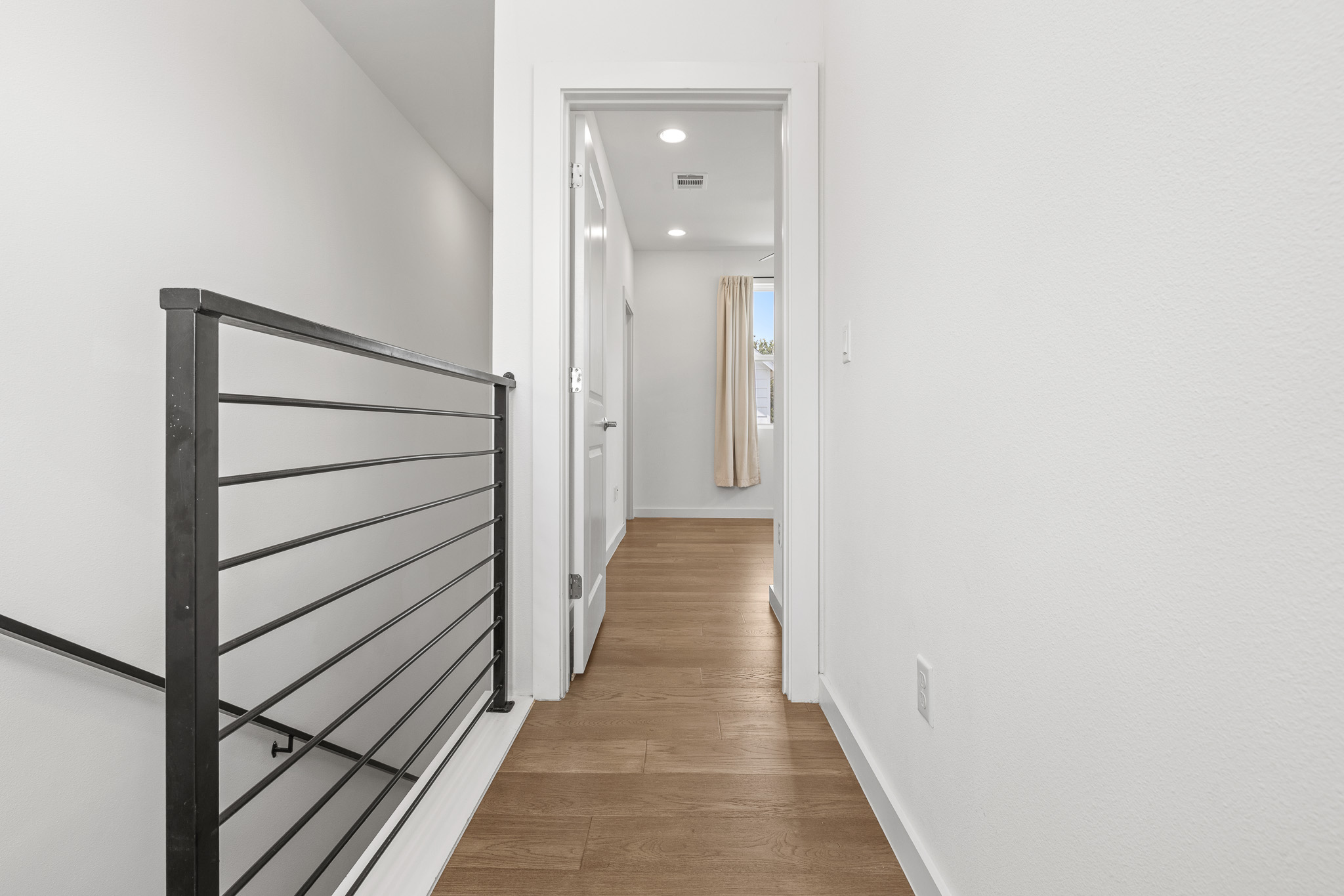 2604 Wheless Lane, Unit 1 Austin, TX 78723 - Photo 16 of 38 Bright, airy landing connects both bedrooms with natural light and open sightlines.