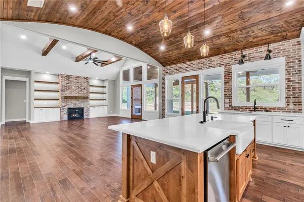a view of a kitchen with a sink and wooden floor