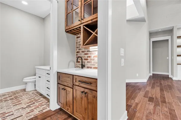 a bathroom with a sink a toilet and a mirror