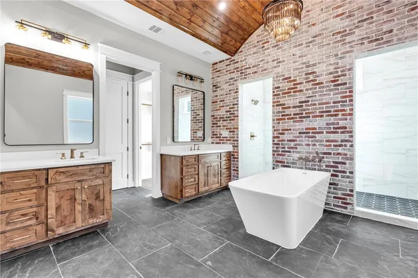 a spacious bathroom with a bathtub and double vanity