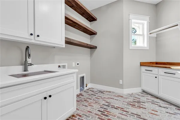 a room with a sink and cabinets