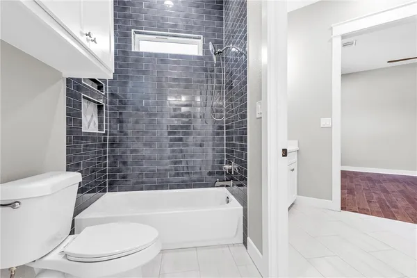 a bathroom with a toilet and bathtub
