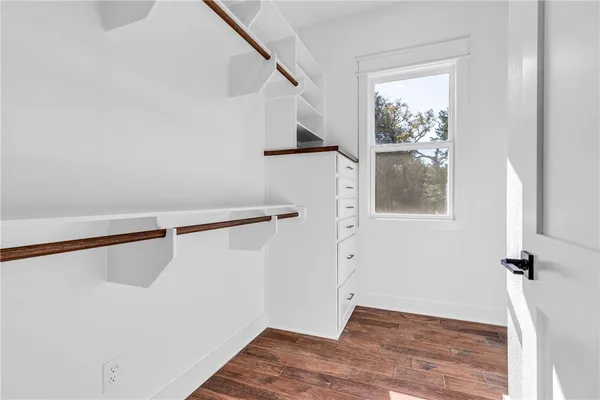 a view of a room with wooden floor and staircase