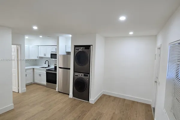a kitchen with refrigerator and cabinets