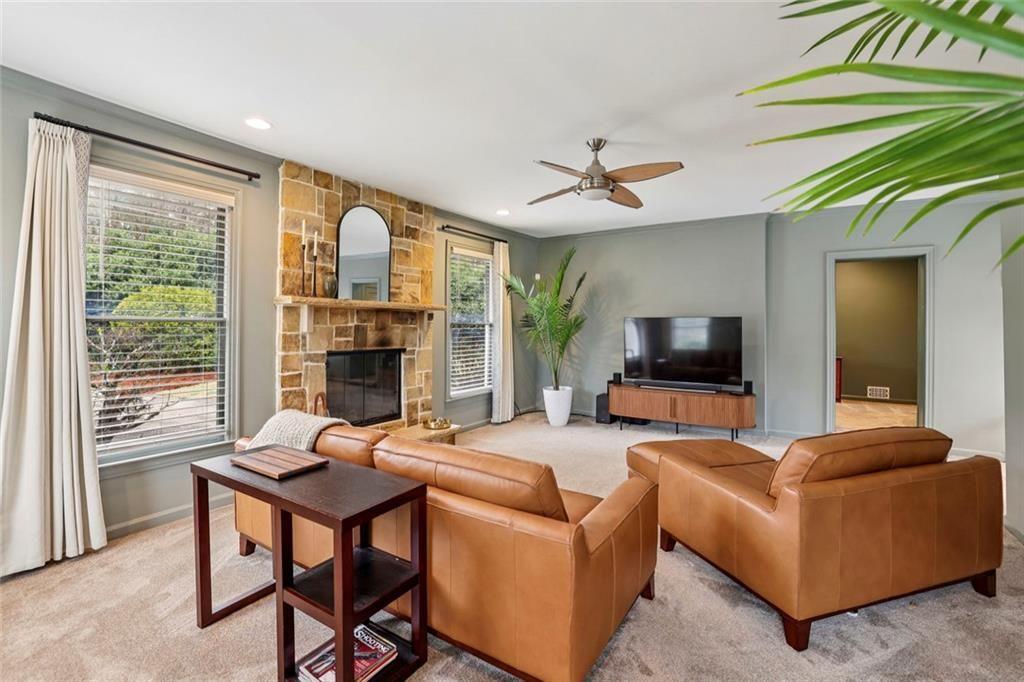 13325 Providence Road Milton, GA 30009 - Photo 19 of 50 a living room with furniture a fireplace and a flat screen tv