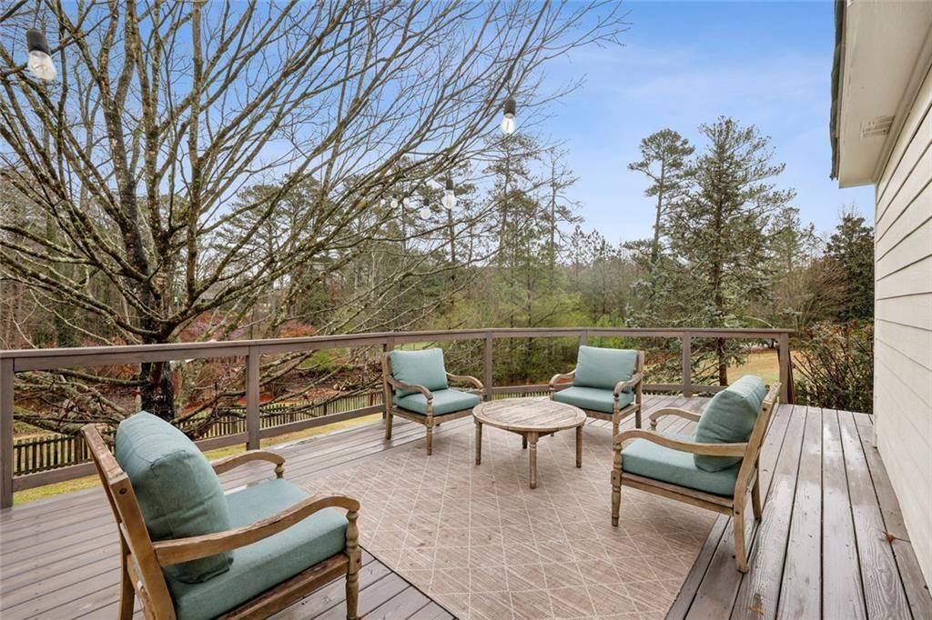 13325 Providence Road Milton, GA 30009 - Photo 30 of 50 a balcony with wooden floor table and chairs
