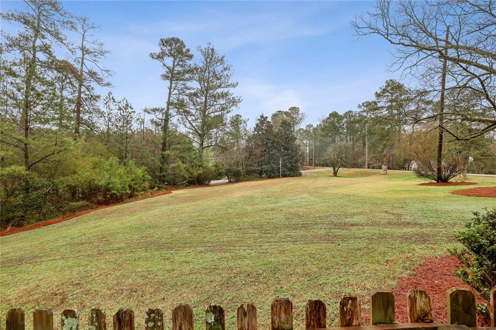 13325 Providence Road Milton, GA 30009 - Photo 31 of 50 a large yard with swimming pool and trees in the background