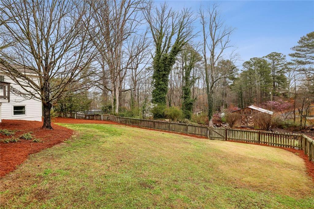 13325 Providence Road Milton, GA 30009 - Photo 32 of 50 a view of a outdoor space with a bench and trees