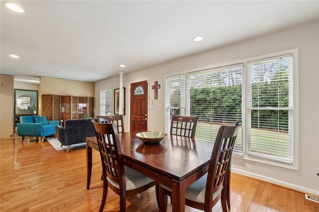 13325 Providence Road Milton, GA 30009 - Photo 7 of 50 a view of a dining room with furniture and wooden floor