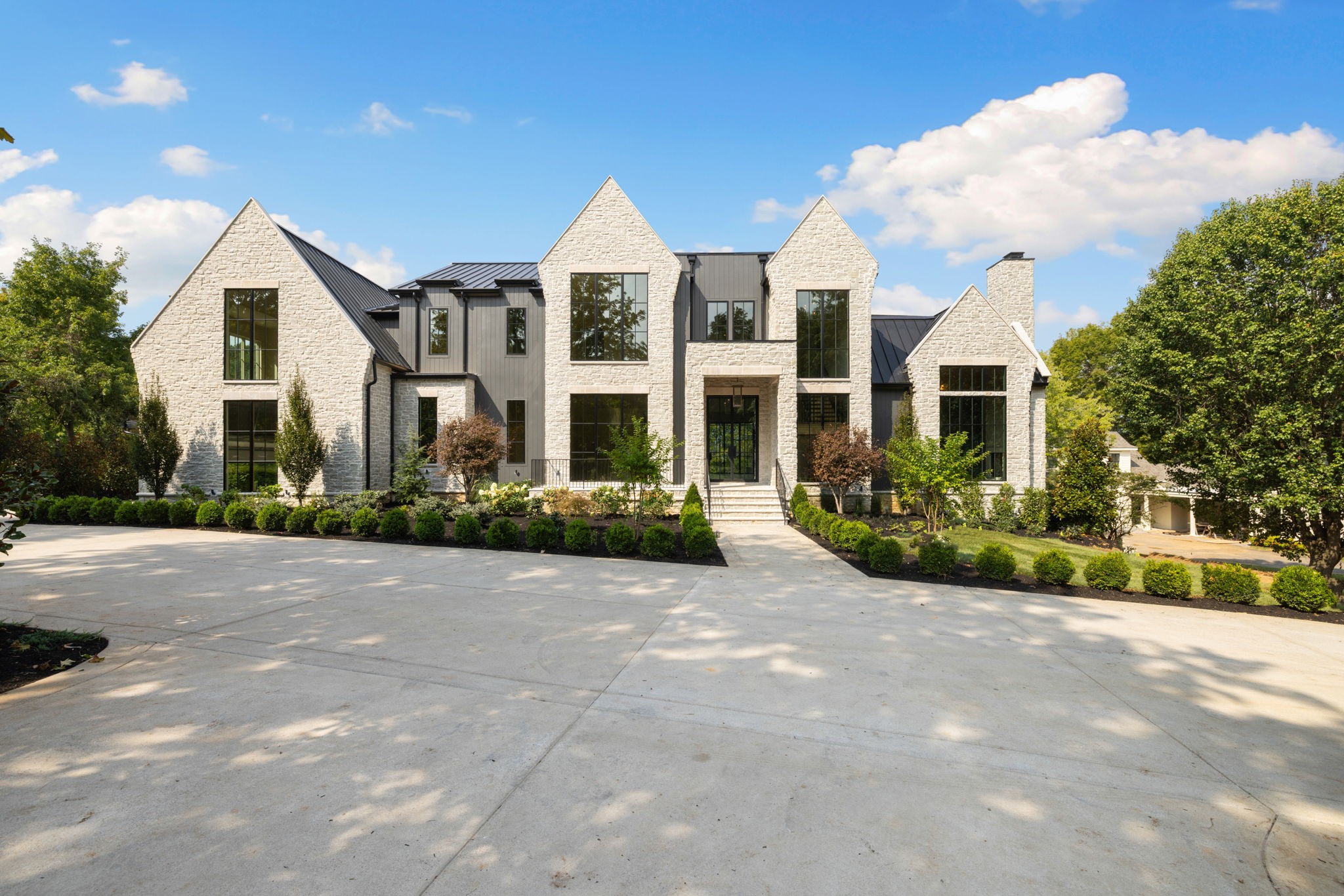 6030 Bresslyn Road Nashville, TN 37205 - Photo 4 of 59 a view of a white house with a yard and plants