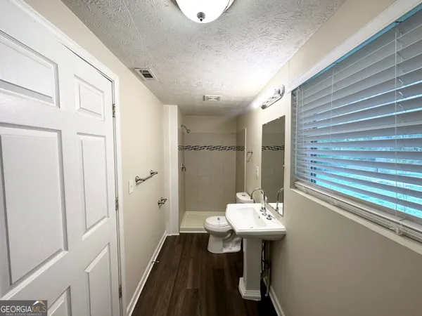 a bathroom with a sink a mirror and a shower