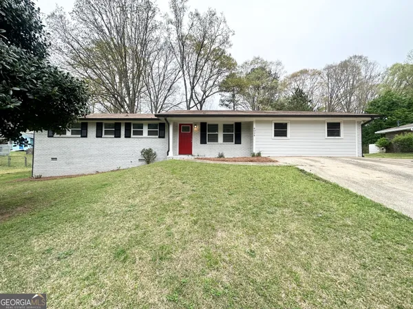 a front view of house with yard and green space