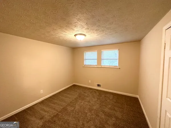 an empty room with a empty space and windows