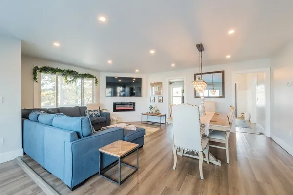 a living room with furniture and a wooden floor